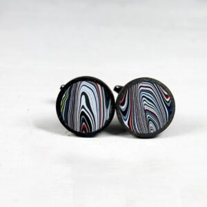 Colorful patterned cufflinks on white background.