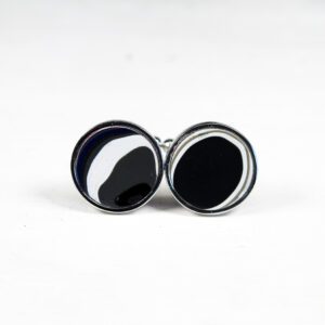 Black and white round cufflinks on display.