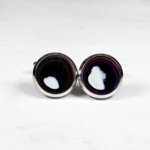 Round cufflinks with abstract black and white design.