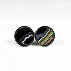Colorful round cufflinks with wavy patterns.