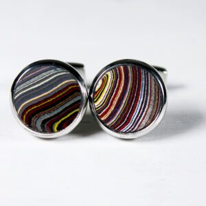 Colorful striped round cufflinks on white background.