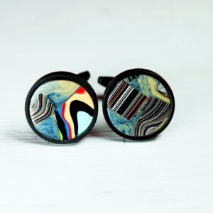 Colorful round cufflinks with abstract patterns.