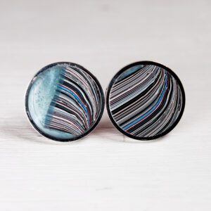 Colorful striped circular earrings on white background.