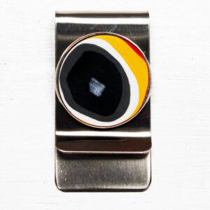 Metal money clip with colorful circular design.
