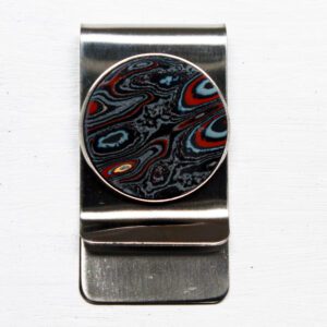 Metal money clip with colorful circular design.