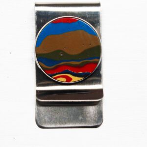 Metallic clip with colorful abstract round design.