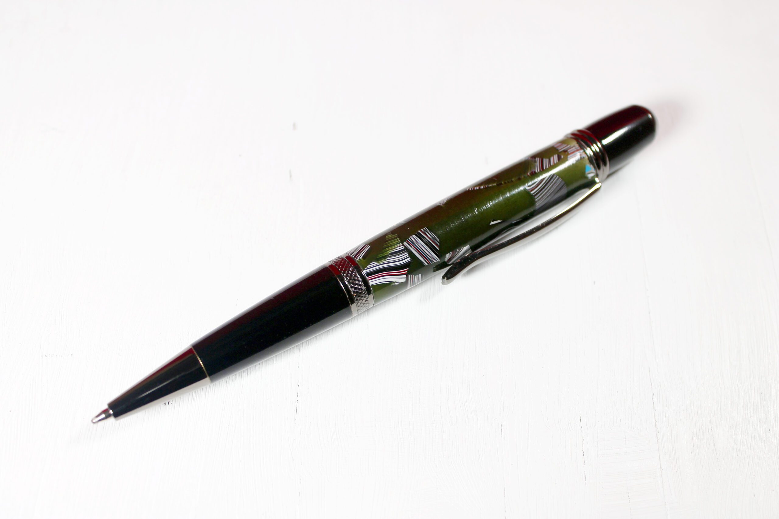 Black and green ballpoint pen on white.