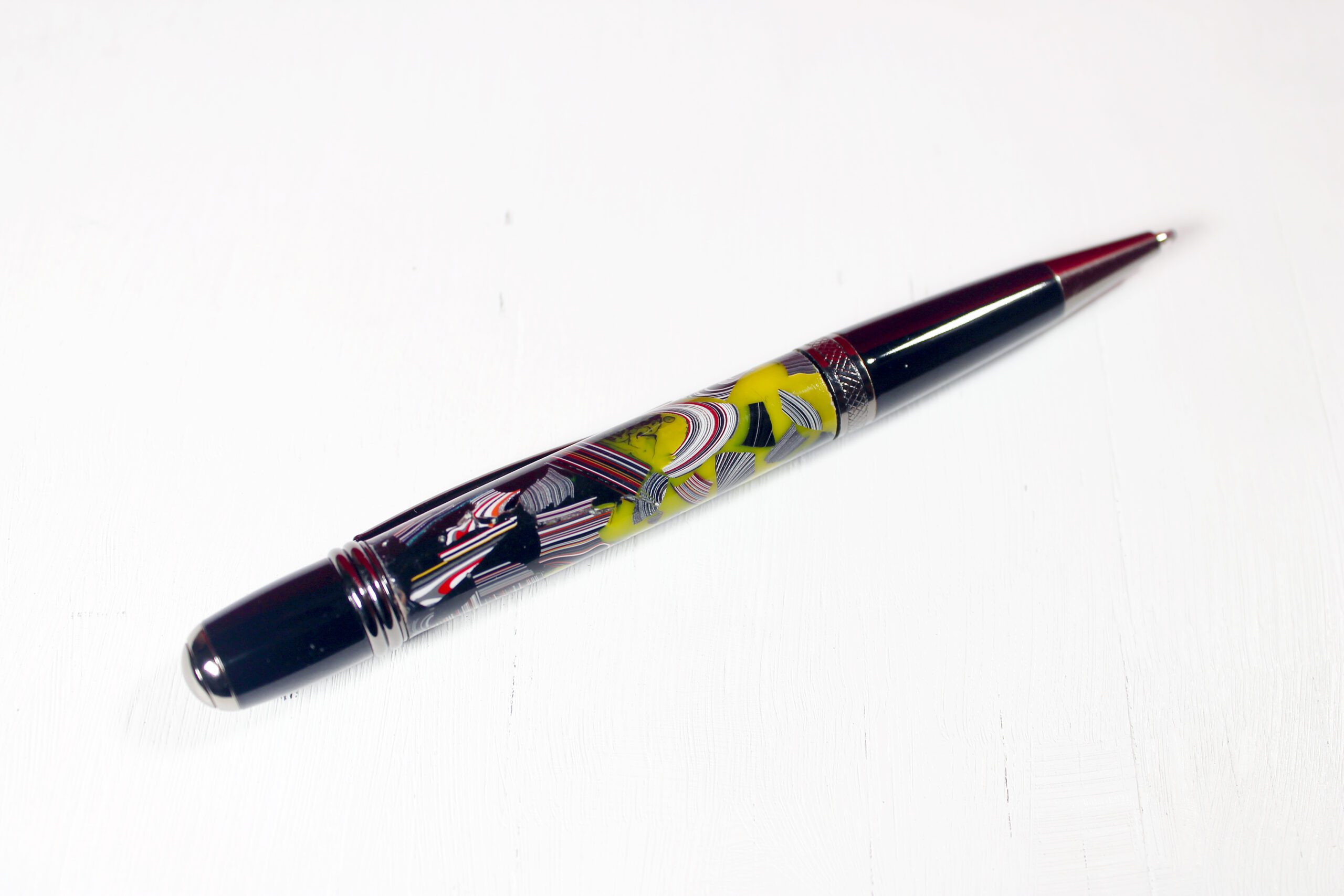 Colorful pen with intricate decorative design.