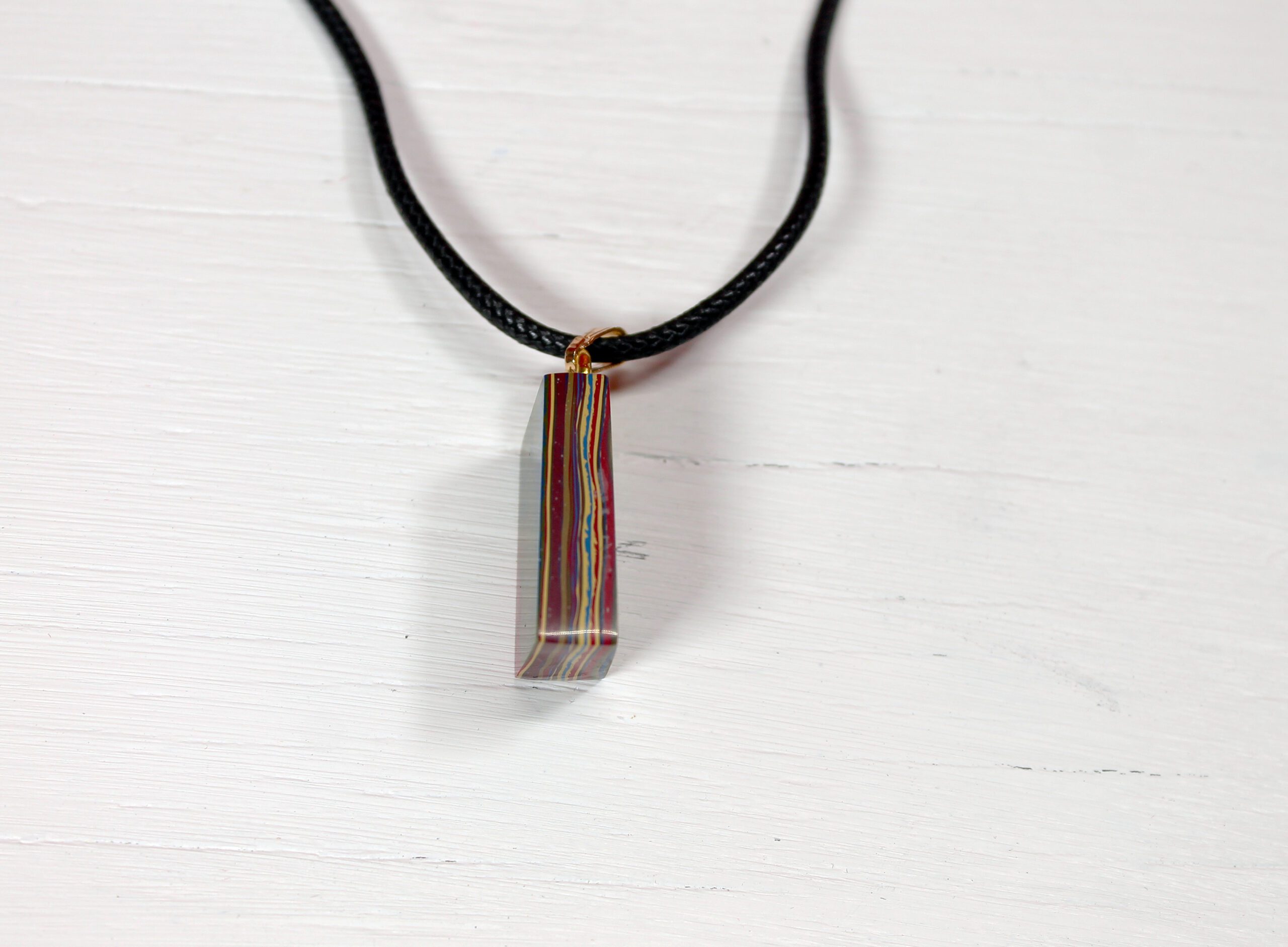 Colorful pendant necklace on white background.