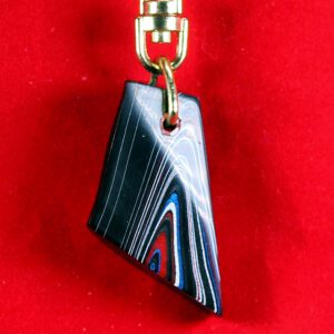 Colorful pendant on a gold chain.