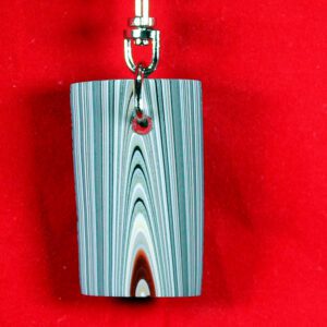 Colorful keychain against a red background.