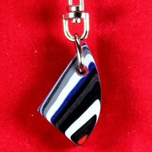 Striped keychain on bright red background.
