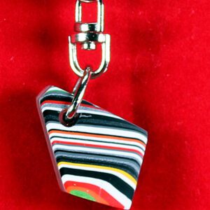 Colorful striped keychain on red background.
