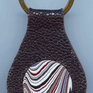 Textured keychain with colorful circular design.