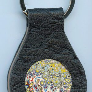 Leather keychain with colorful circular design.