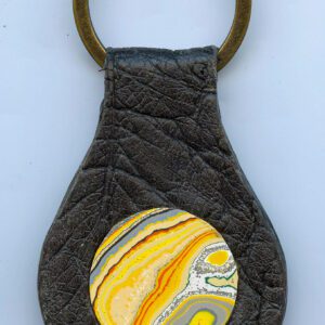 Leather keychain with colorful round design.