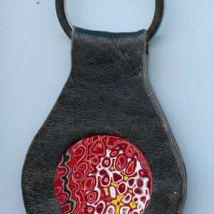 Leather keychain with colorful circular design.