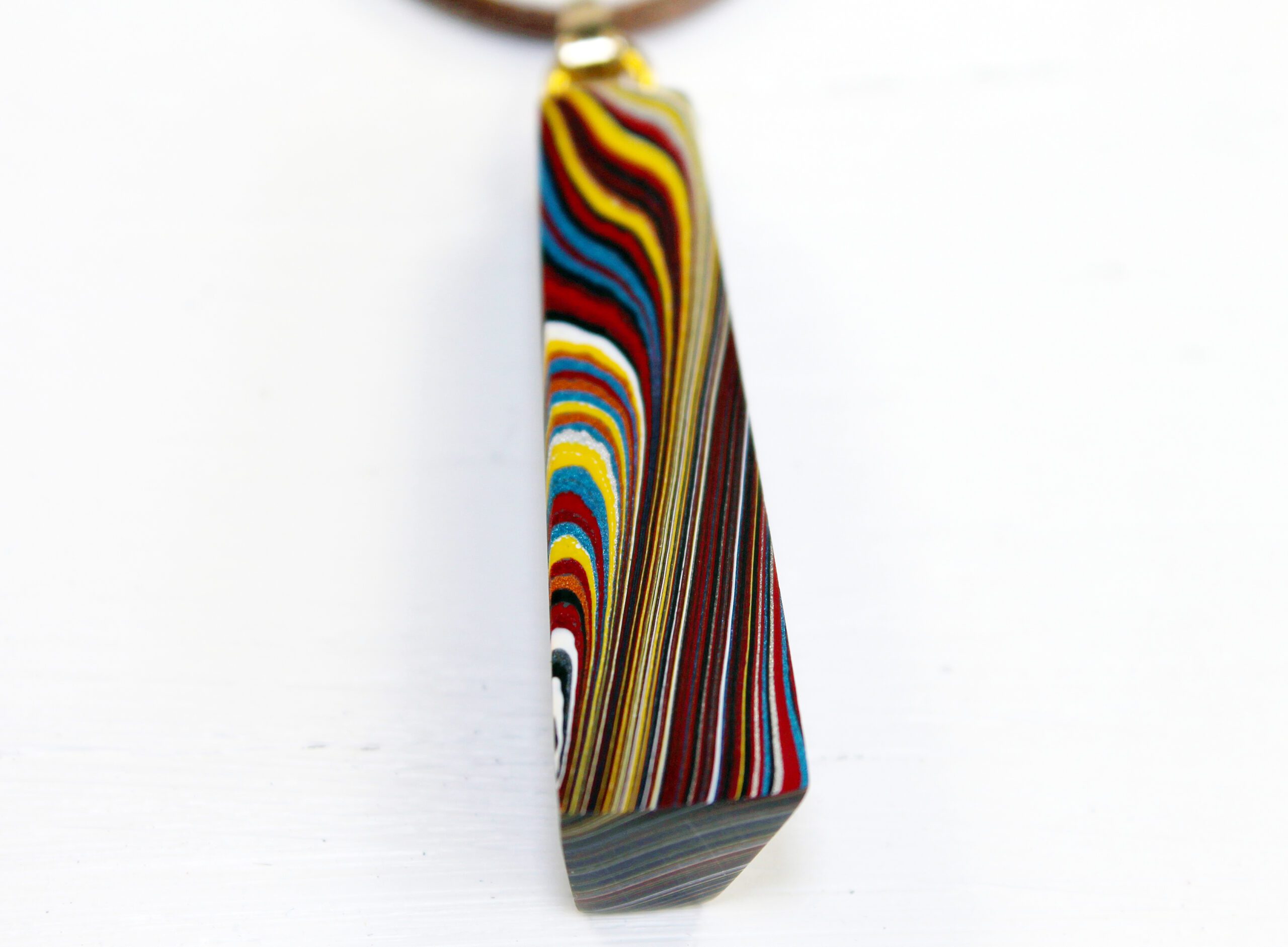 Colorful striped pendant on a white background.