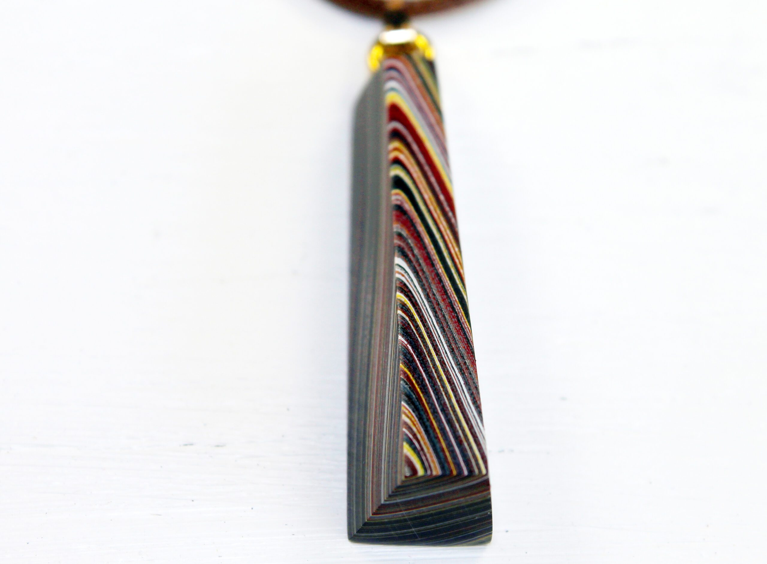 Colorful striped pendant on a white background.