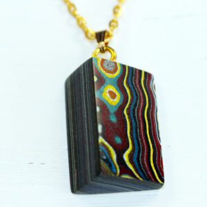 Colorful pendant with geometric, wavy patterns.
