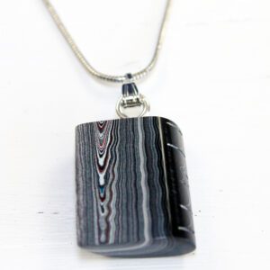 Striped pendant on a silver chain.