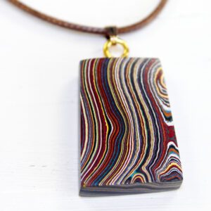 Rectangular pendant with colorful layered design.
