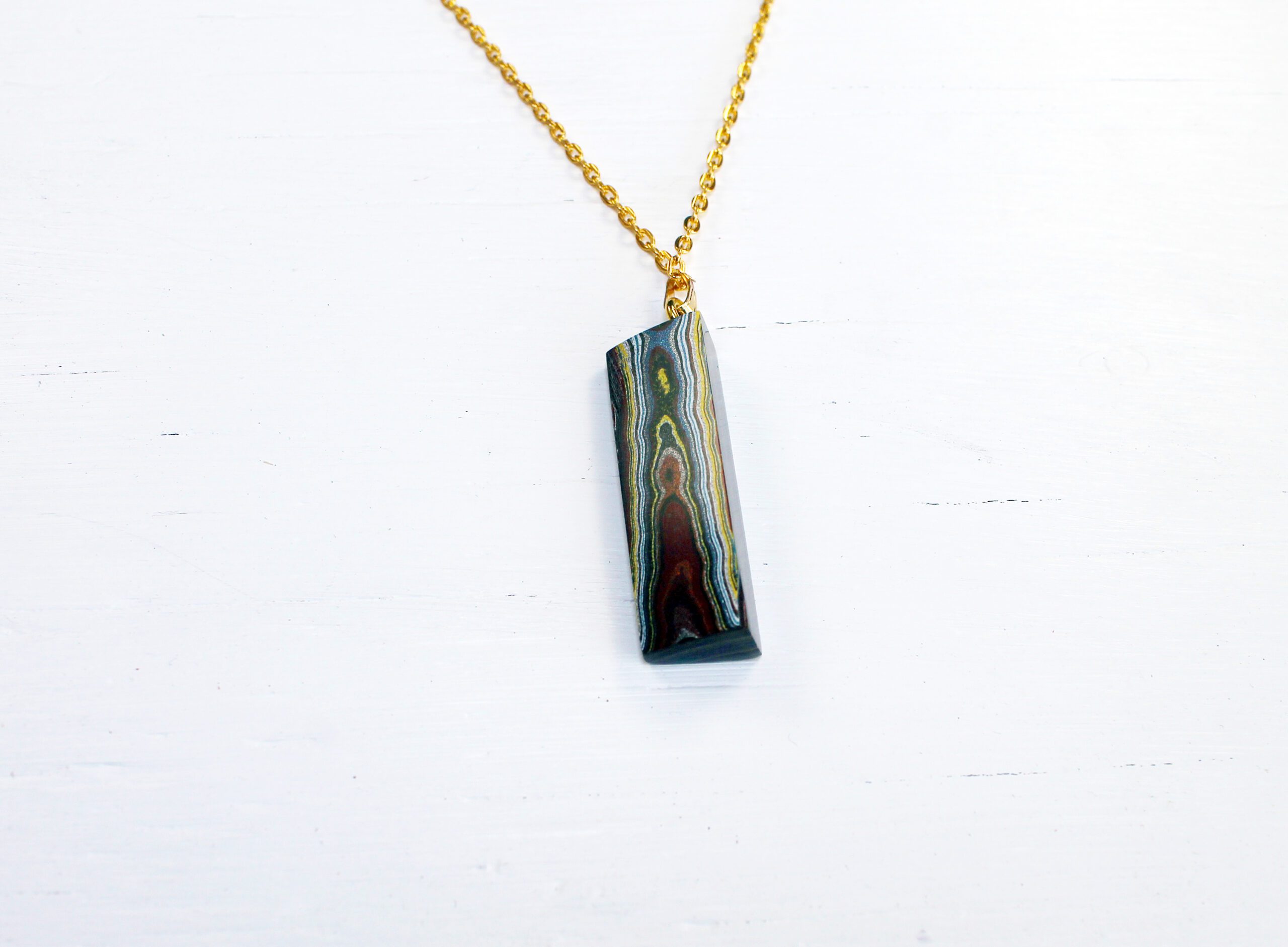 Pendant necklace with colorful stone design.