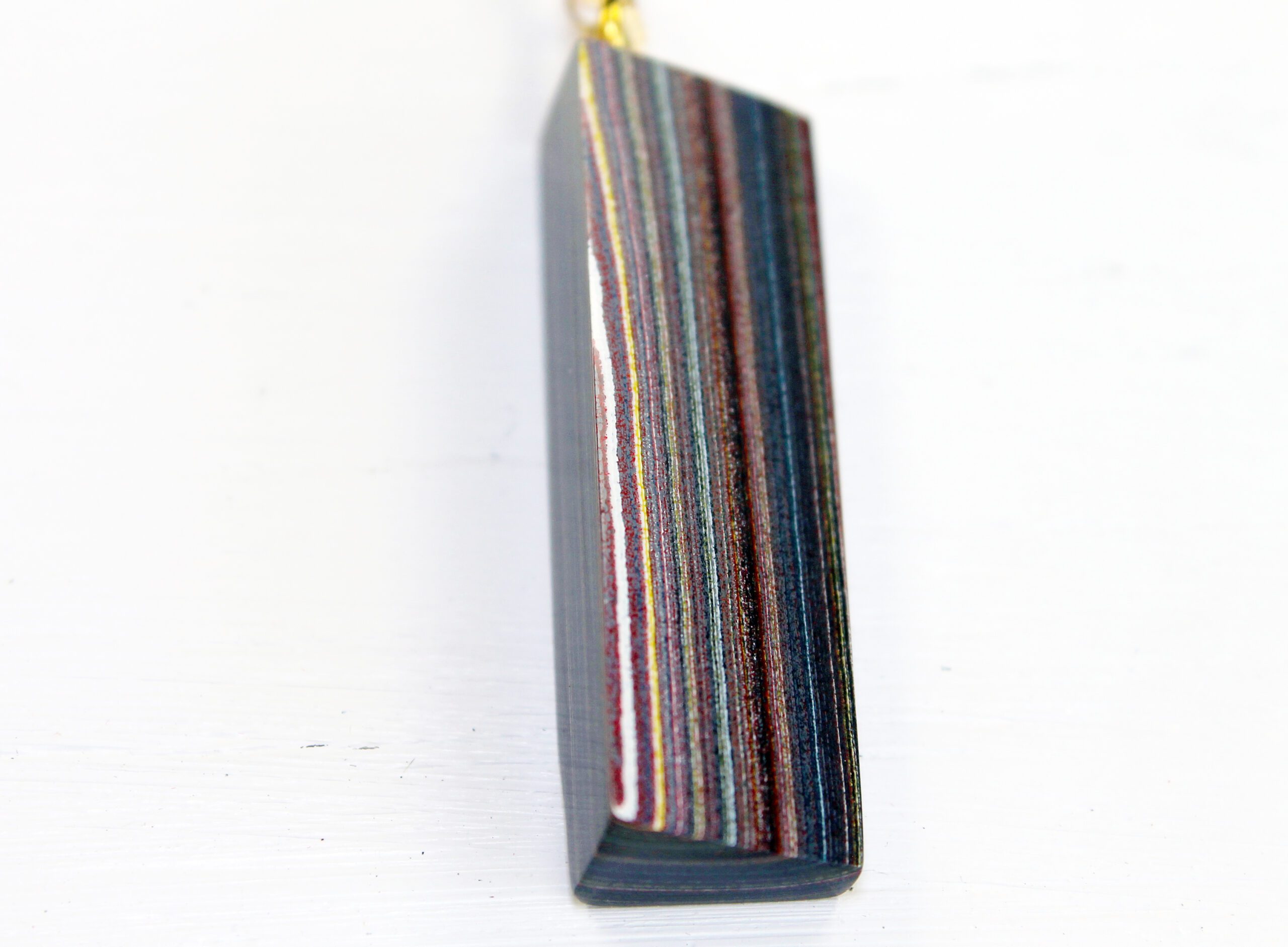 Colorful striped pendant on white background.
