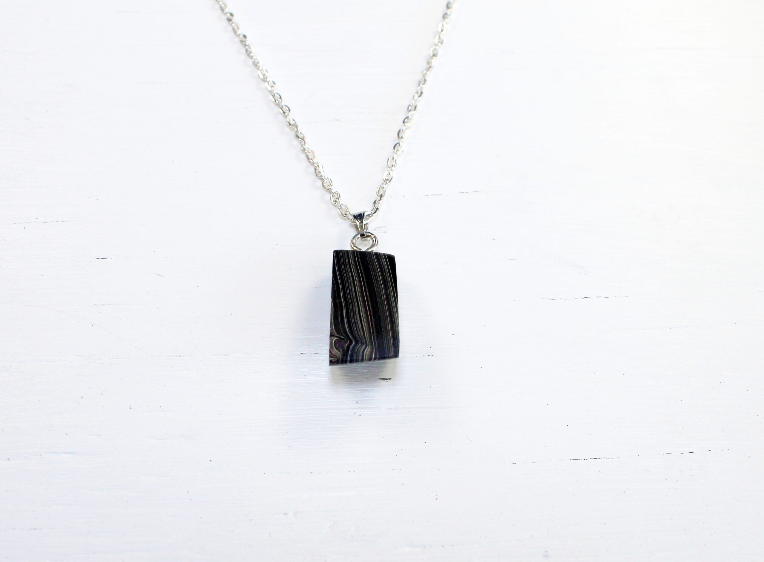 Rectangular pendant on a silver chain.