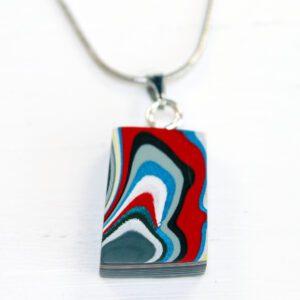 Colorful abstract pendant on a silver chain.