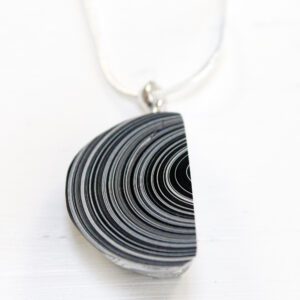 Black and white striped pendant necklace.