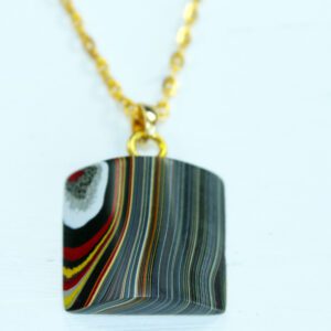 Colorful pendant with striped pattern on chain.