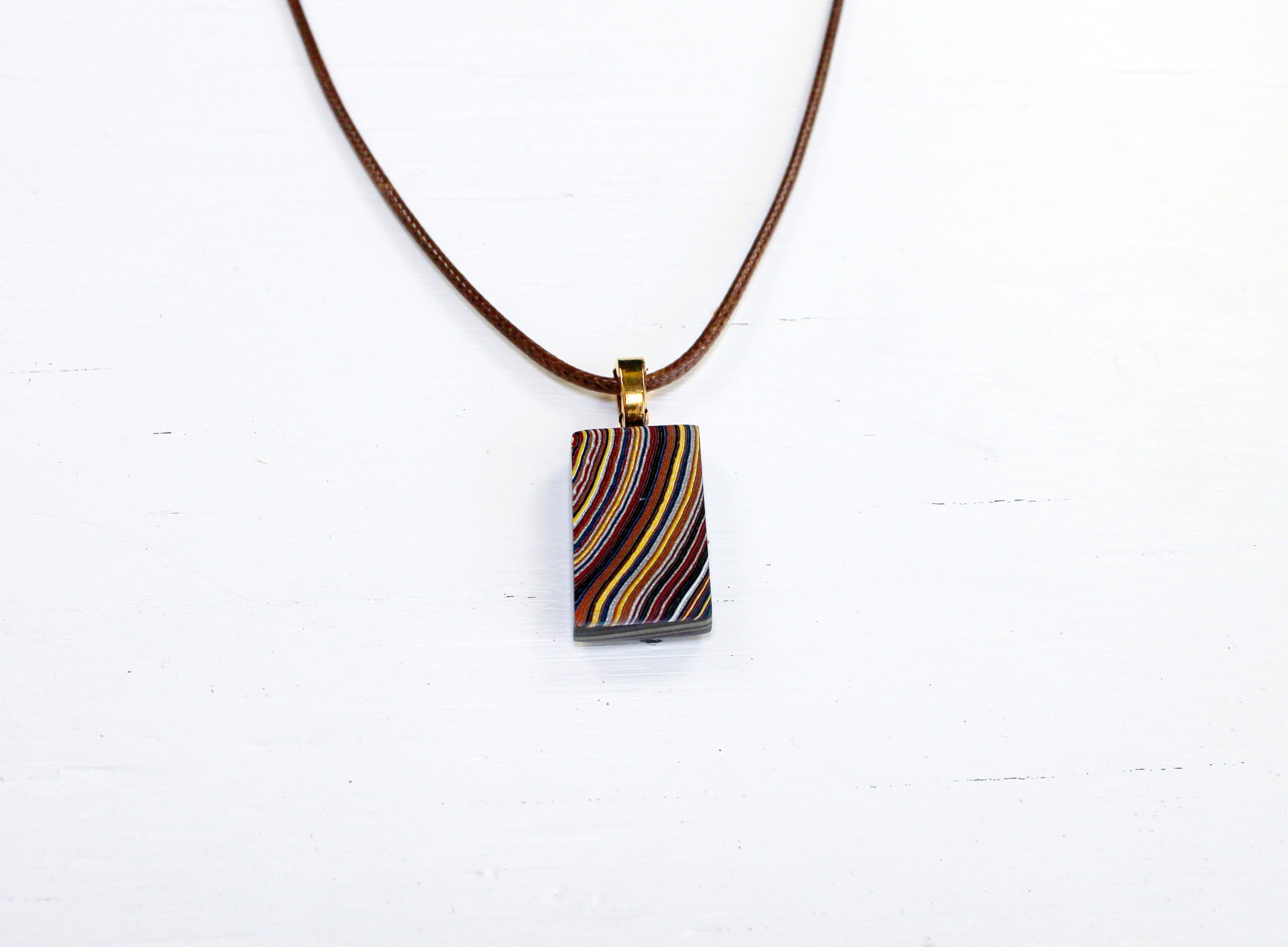 Colorful pendant necklace on white background.