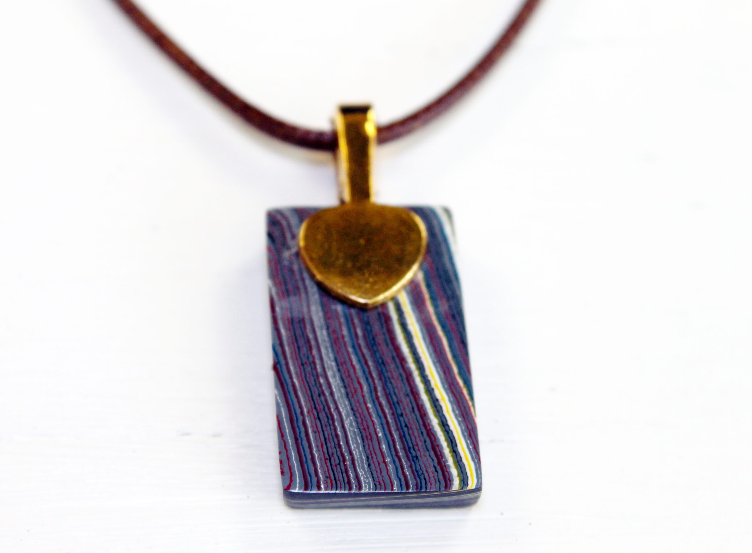 Colorful pendant necklace with gold accent.