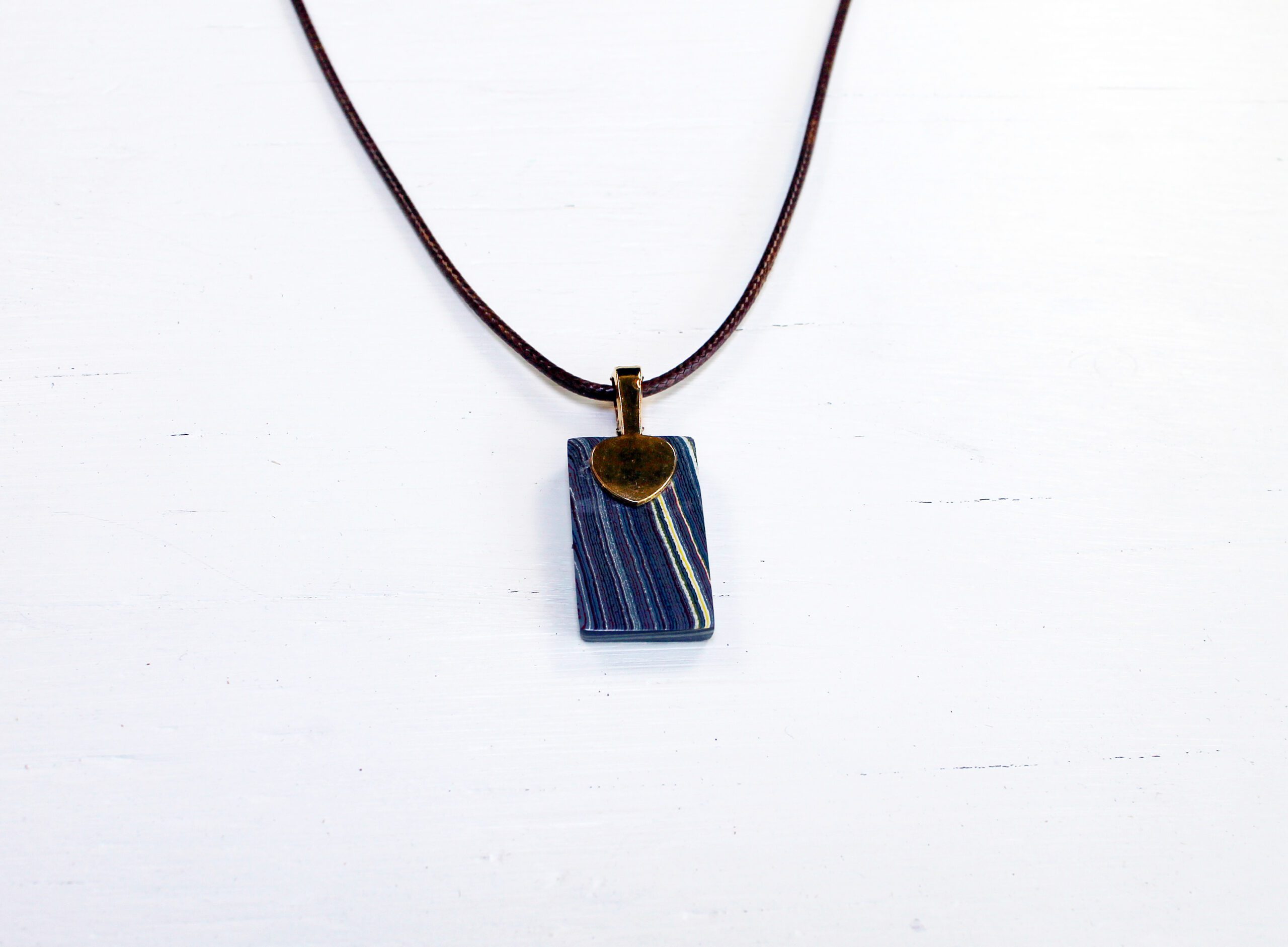 Pendant necklace with a striped design.