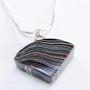 Striped pendant necklace on a white background.