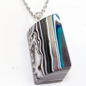 Colorful, striped pendant on a silver chain.