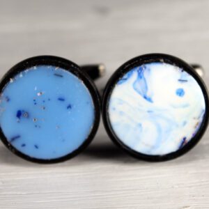 Blue and white circular cufflinks on display.