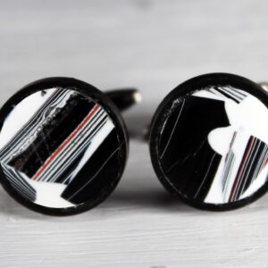 Black and white round cufflinks with stripes.