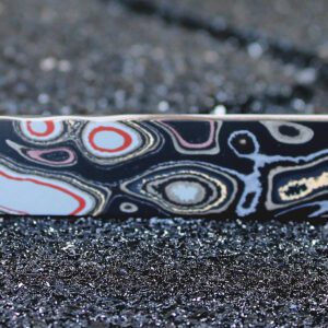 Decorative patterned metal bar on sparkly surface