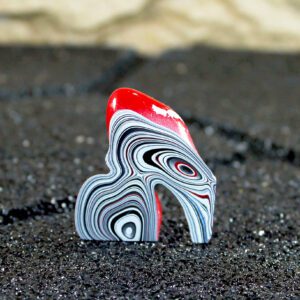 Red-topped layered paint swirl sculpture