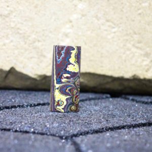 Small colorful marbled stone block standing upright