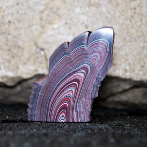 Polished multicolored banded stone slice
