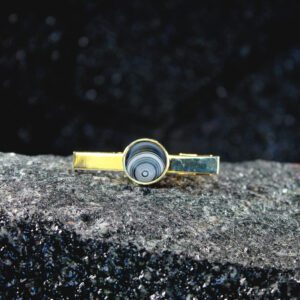 Gold tie clip with concentric blue stone