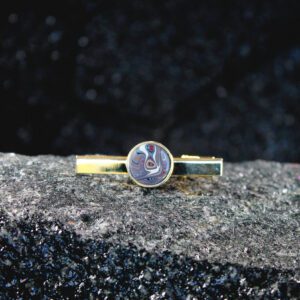 Gold tie clip with marbled round enamel