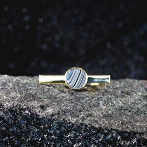 Gold tie clip with round striped stone