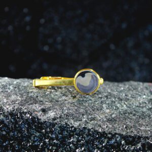 Gold tie clip with round gray swirl