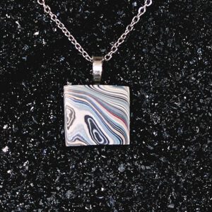 Square swirled pendant necklace on black background