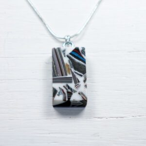 Rectangular patterned pendant necklace on white wood