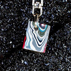 Marbled rectangular pendant keychain on black glitter background